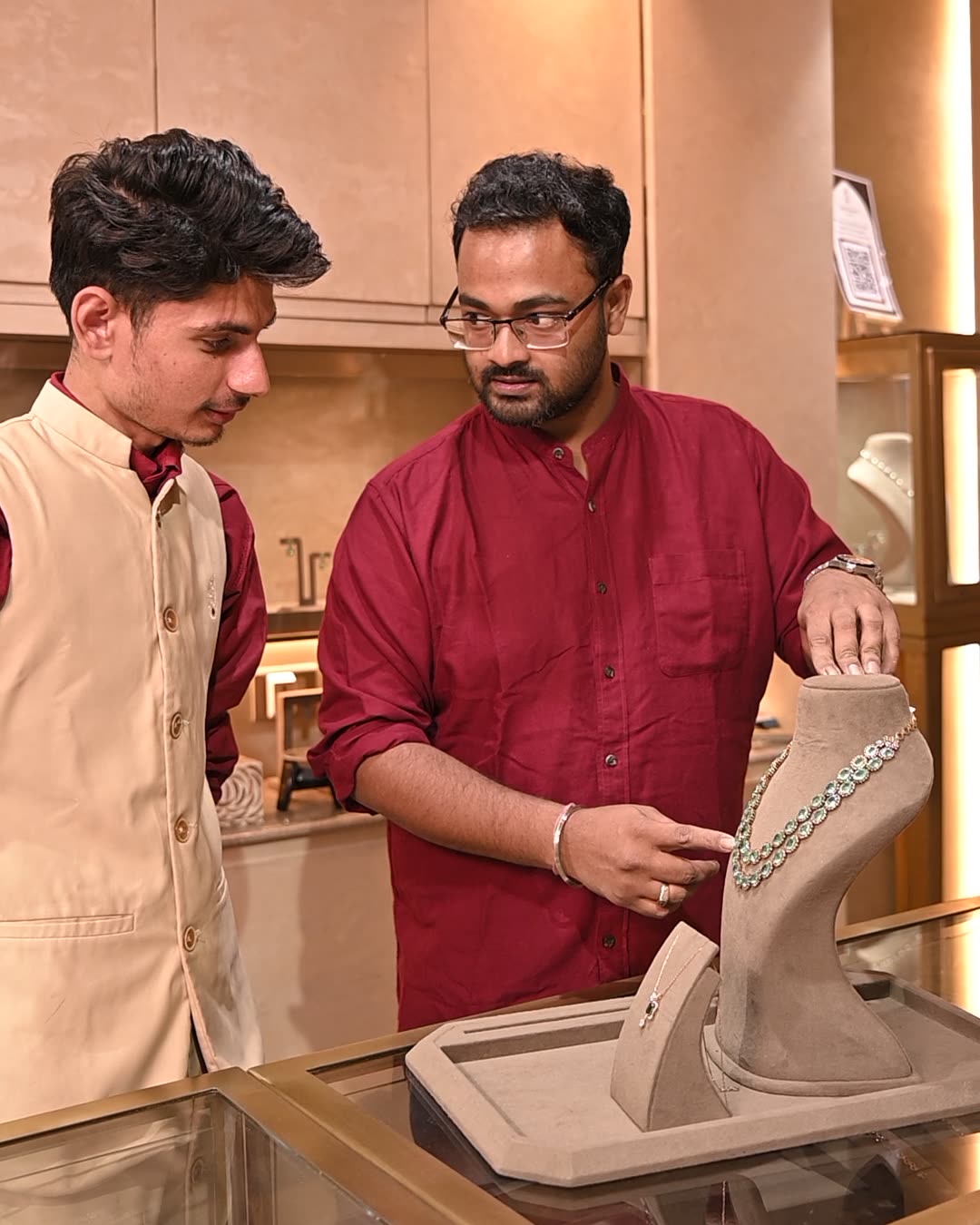 Talking through a necklace at the showroom counter